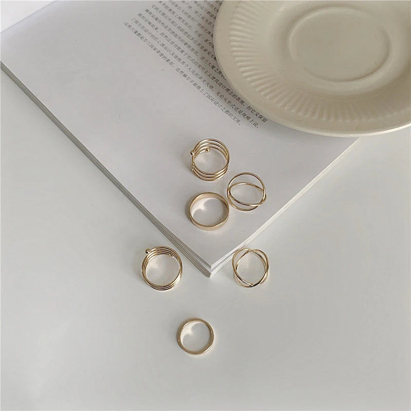 Gold ring set with multiple stacked bands and plain round rings