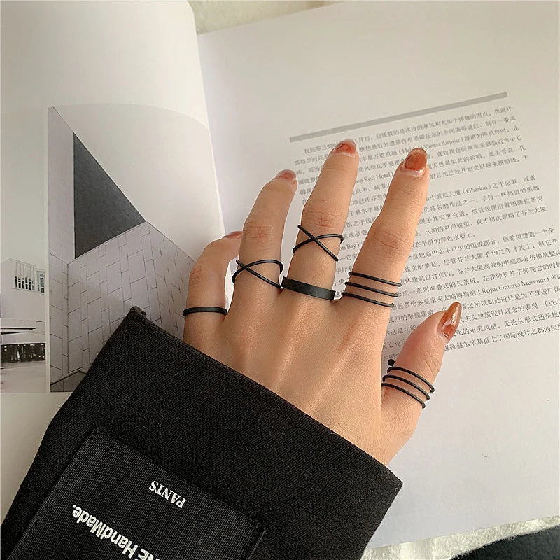Black geometric knuckle rings with stacked bands on fingers