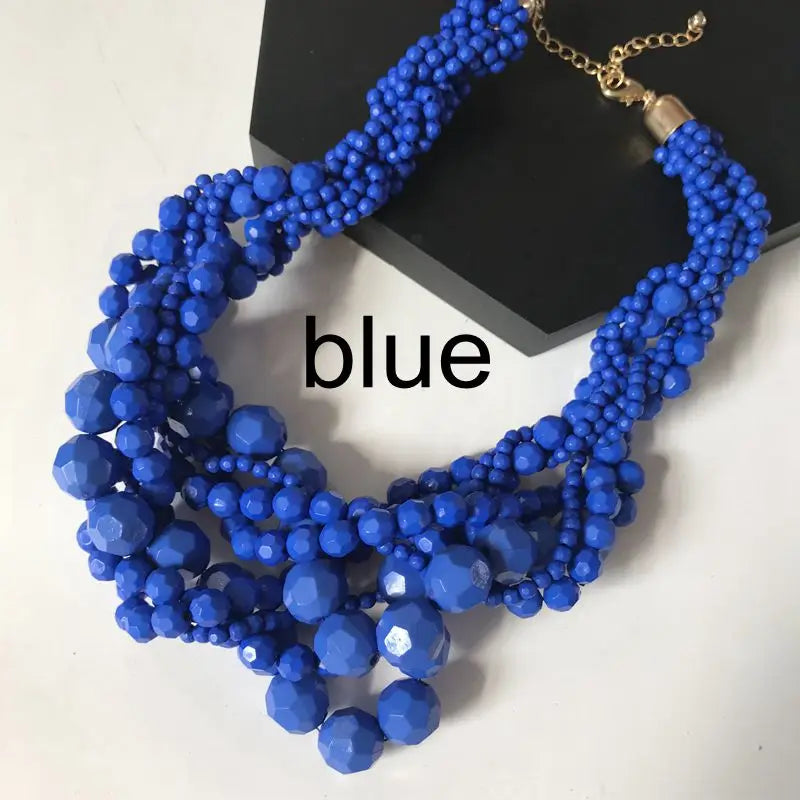 Blue beaded choker necklace with braided bead layers and gold-tone clasp.