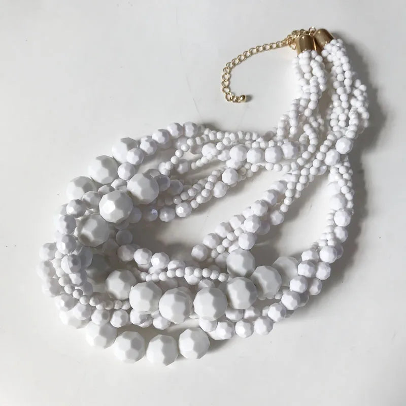 White beaded choker necklace with braided strands and gold-tone chain clasp.