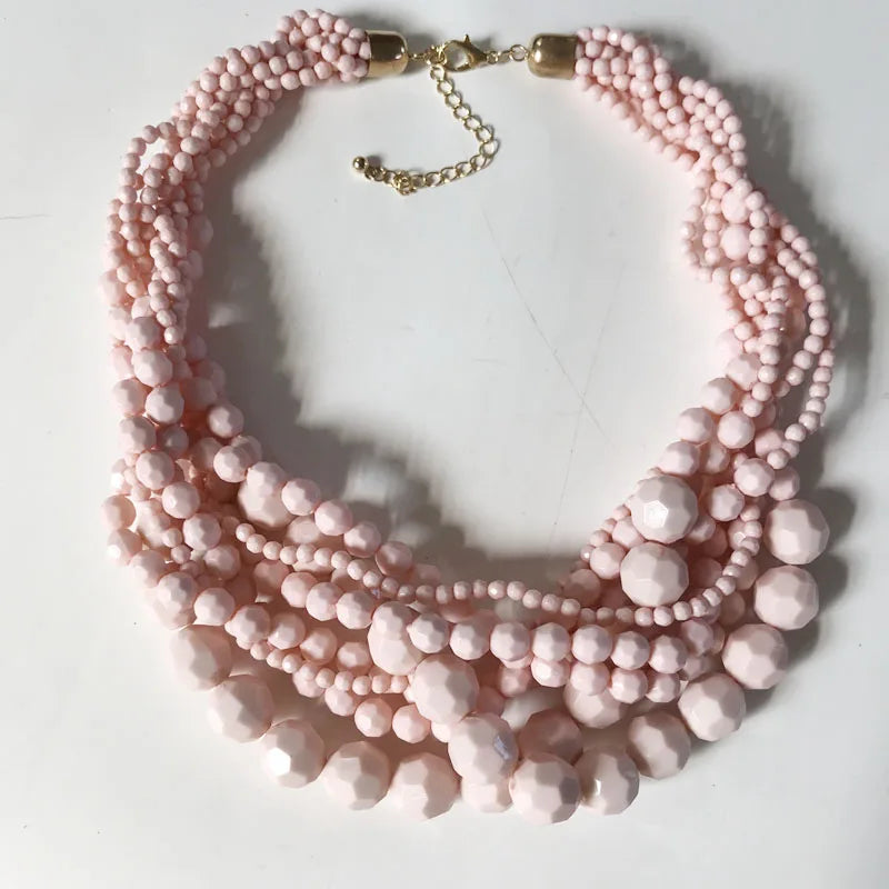 Light pink beaded choker necklace with braided bead layers and gold-tone clasp.