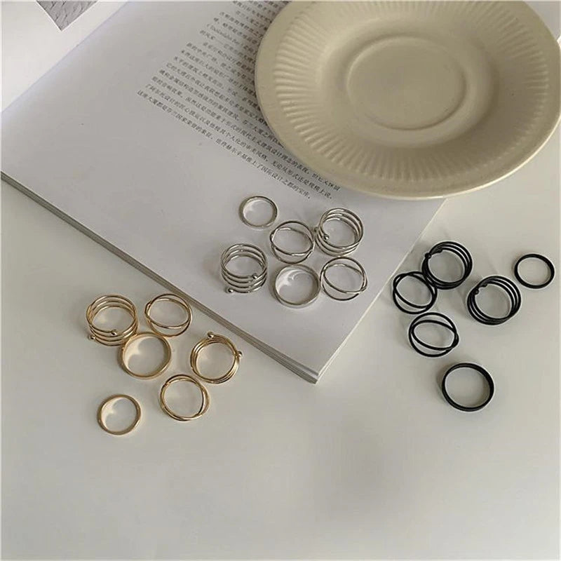 Assorted ring set with gold and silver bands and black stacked rings