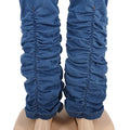Blue denim stacked jeans leg close-up with ruched texture at calves