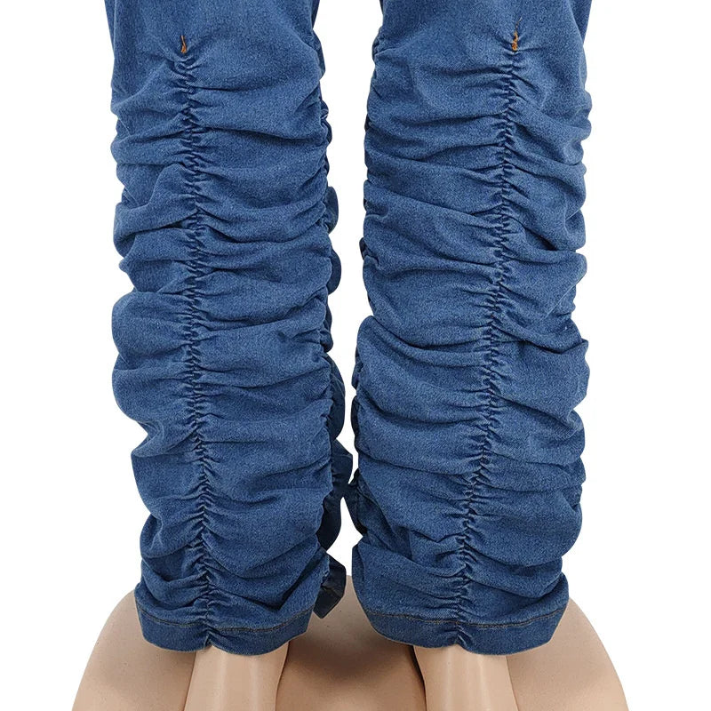 Blue denim stacked jeans leg close-up with ruched texture at calves