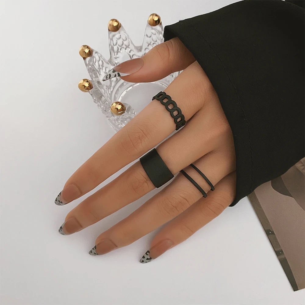 Black chain-link knuckle ring with chunky geometric links, worn on finger