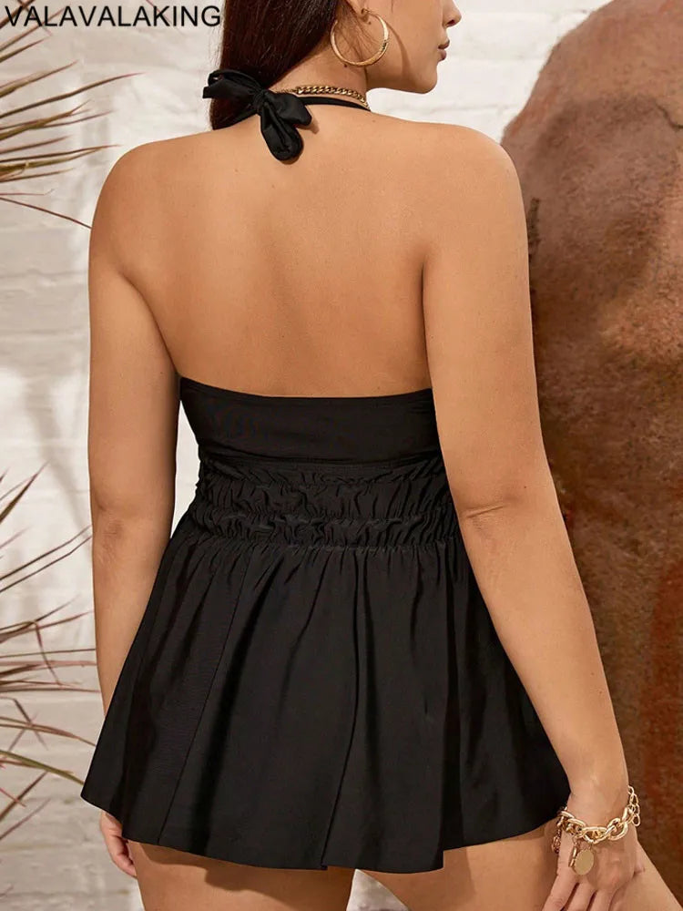 Black halter tankini swim top with open back straps and smocked waist skirt overlay