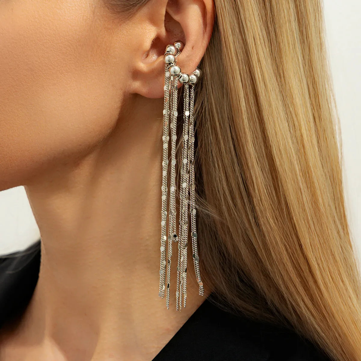 Silver no-pierce ear clip with stacked chain tassels and small round bead charms