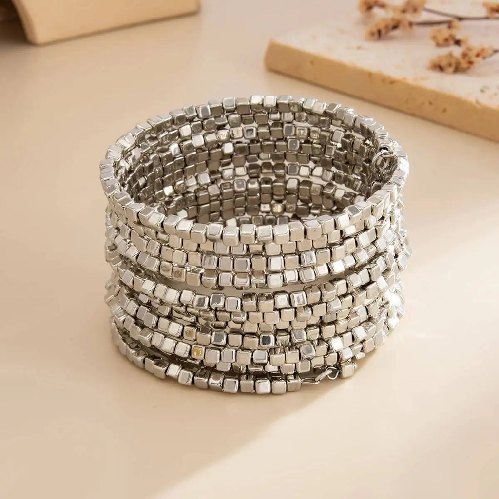 Silver-tone multi-layer wide beaded cuff bracelet with small square bead rows.