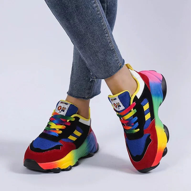 Women's platform sneakers with navy and red uppers, rainbow side gradients, and lace-up front.