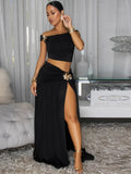 Black off-shoulder cropped top and high-slit maxi skirt set with floral brooch detail