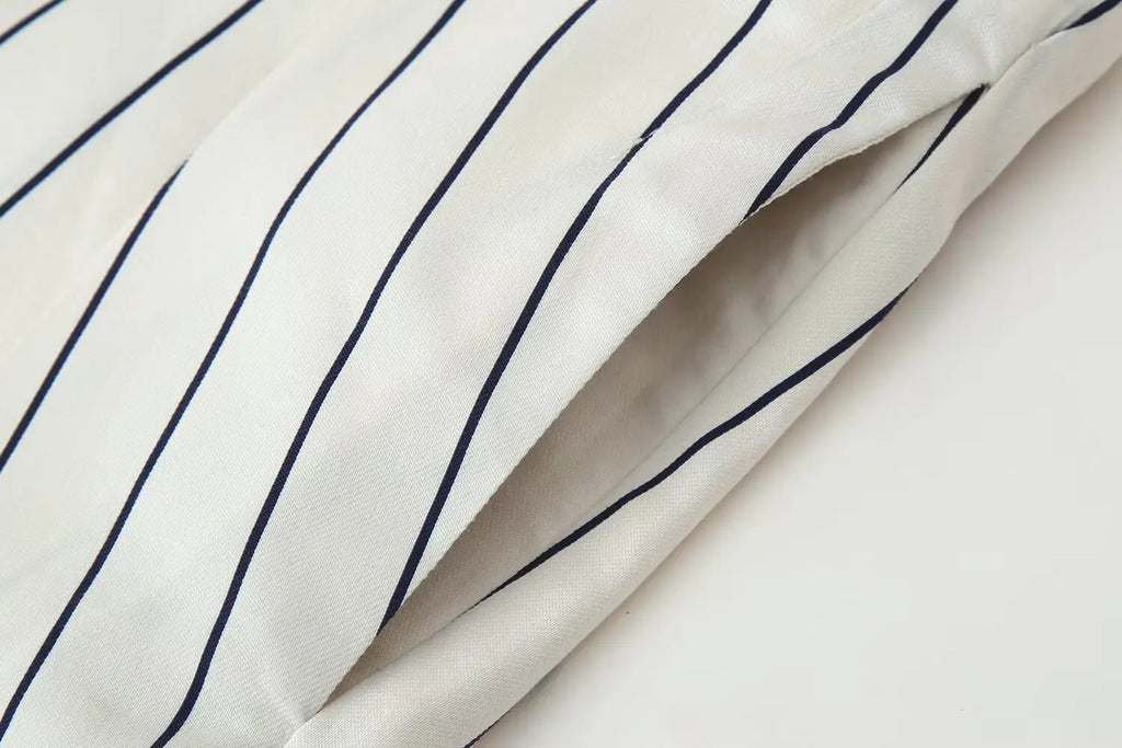 Off-white fabric with navy vertical pinstripes, from a striped shirt