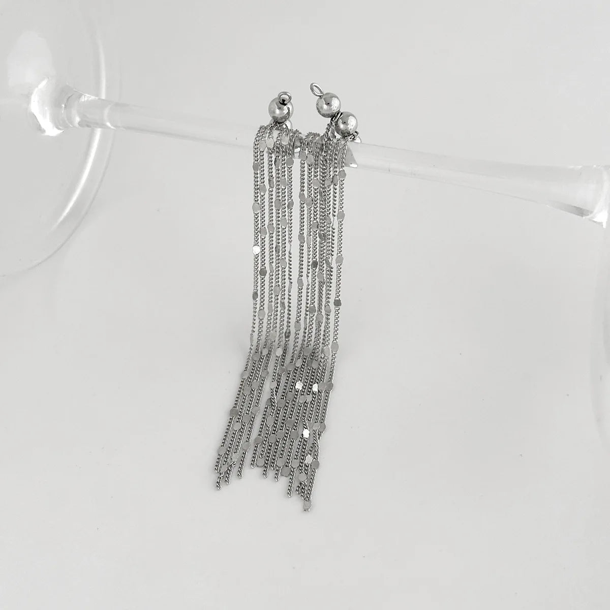Pair of silver chain tassel ear clips hanging with round top accents