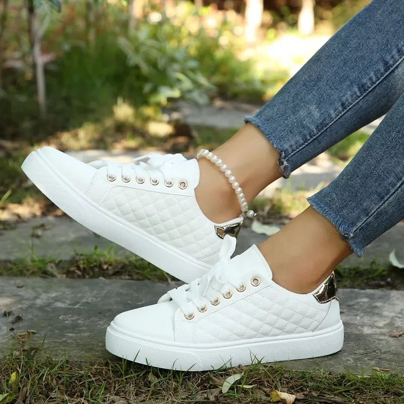 White quilted lace-up platform sneakers with gold eyelets and thick white rubber sole