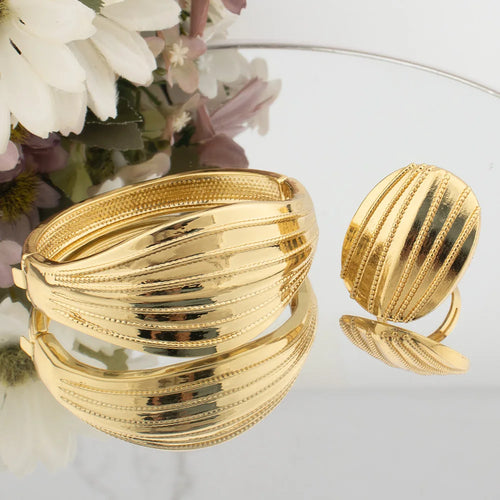 Gold-tone ribbed oversized bangle and wide matching ring with stacked stripe texture