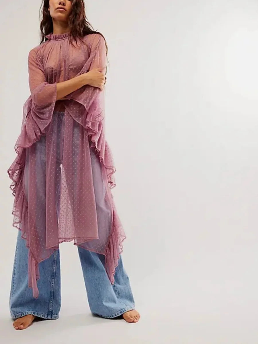 Sheer pink poncho cover-up with ruffled edges and long flowing sleeves