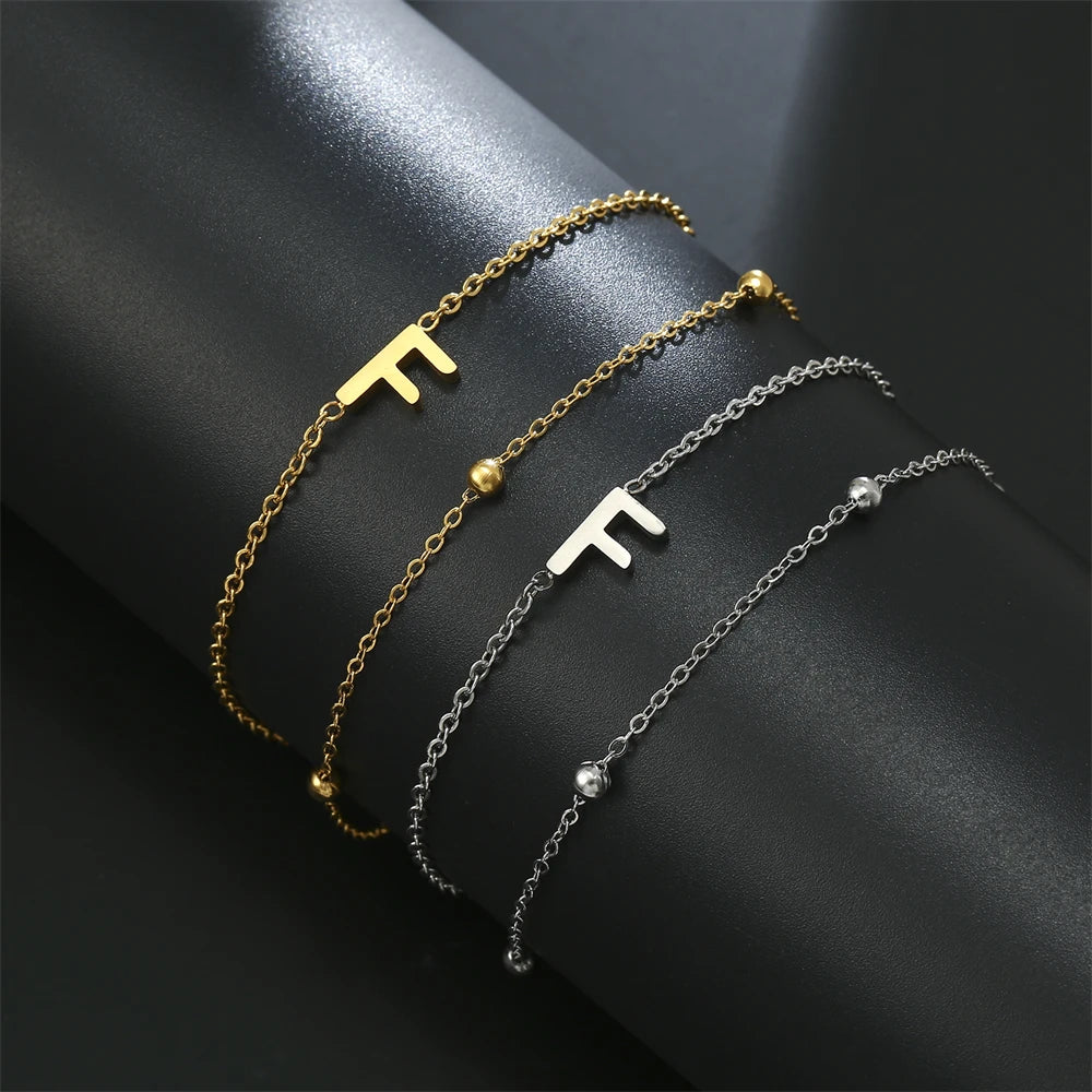 Initial letter bracelet set with T and T charms; gold and silver-tone chains