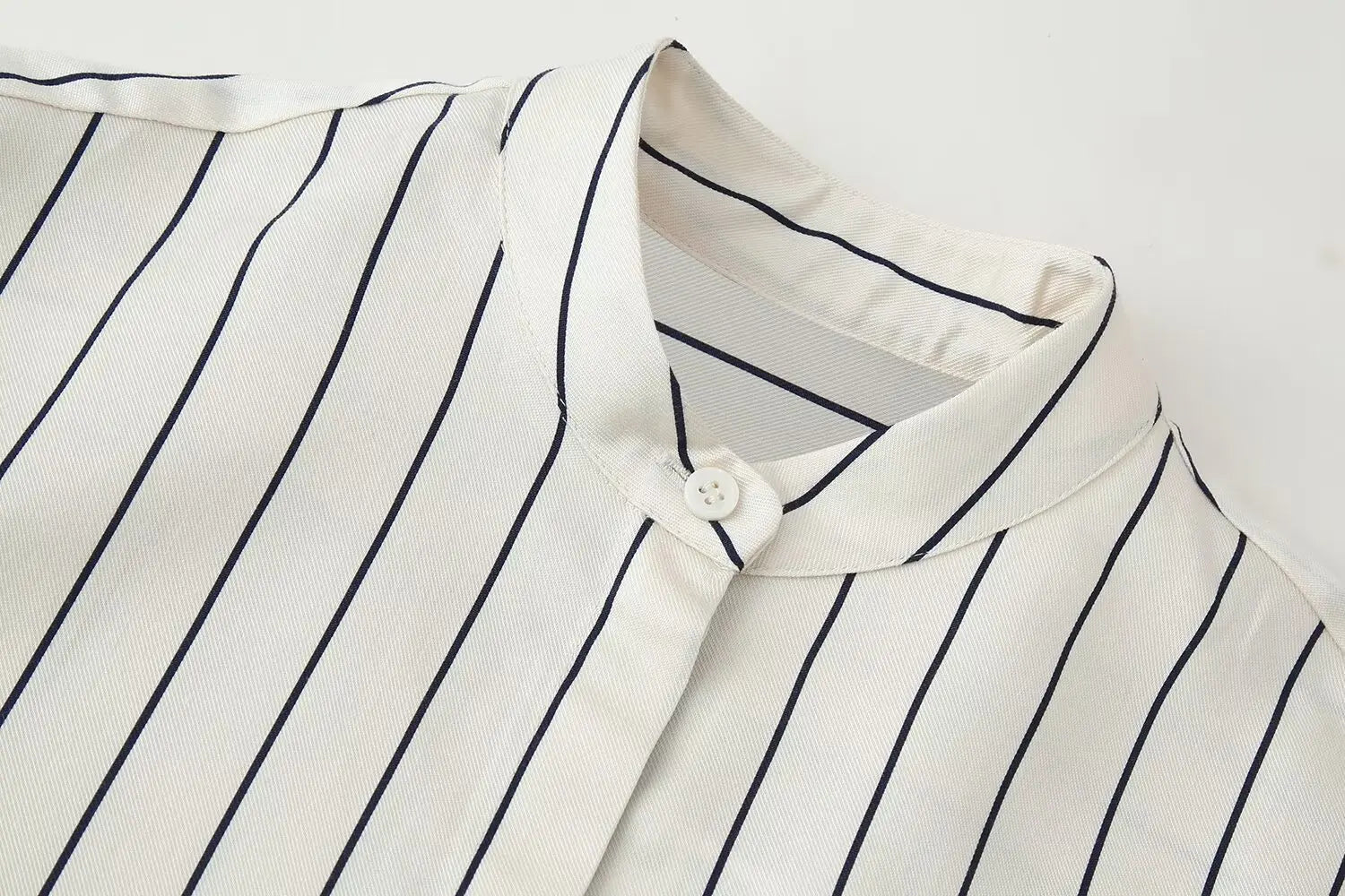 Striped button-up shirt collar and placket, off-white with navy vertical pinstripes