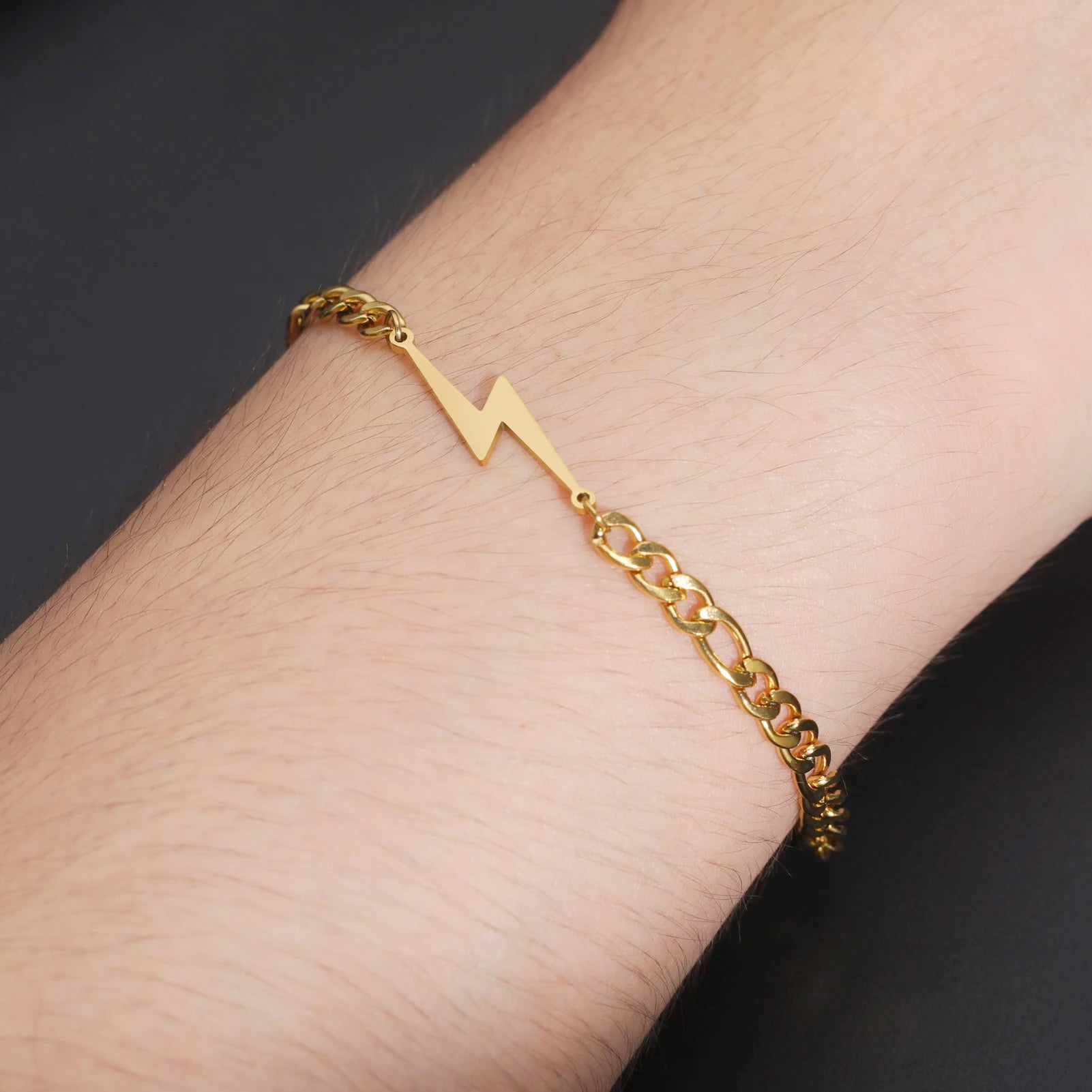 Gold-tone chain lightning bolt charm bracelet on wrist