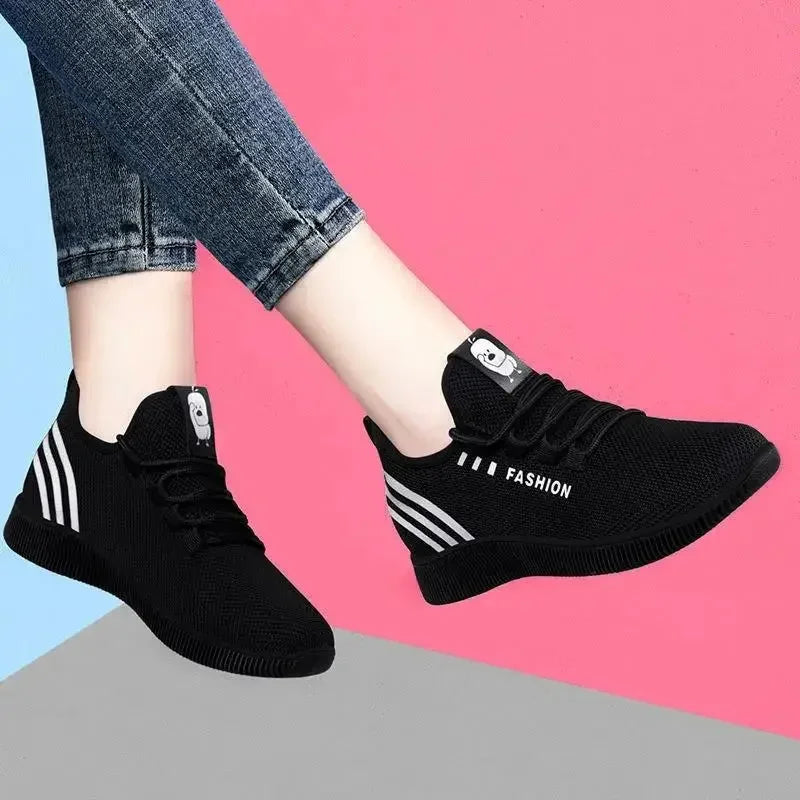Black knit sneakers with white side stripes, lace-up, Velcro pull tab, cushioned sole