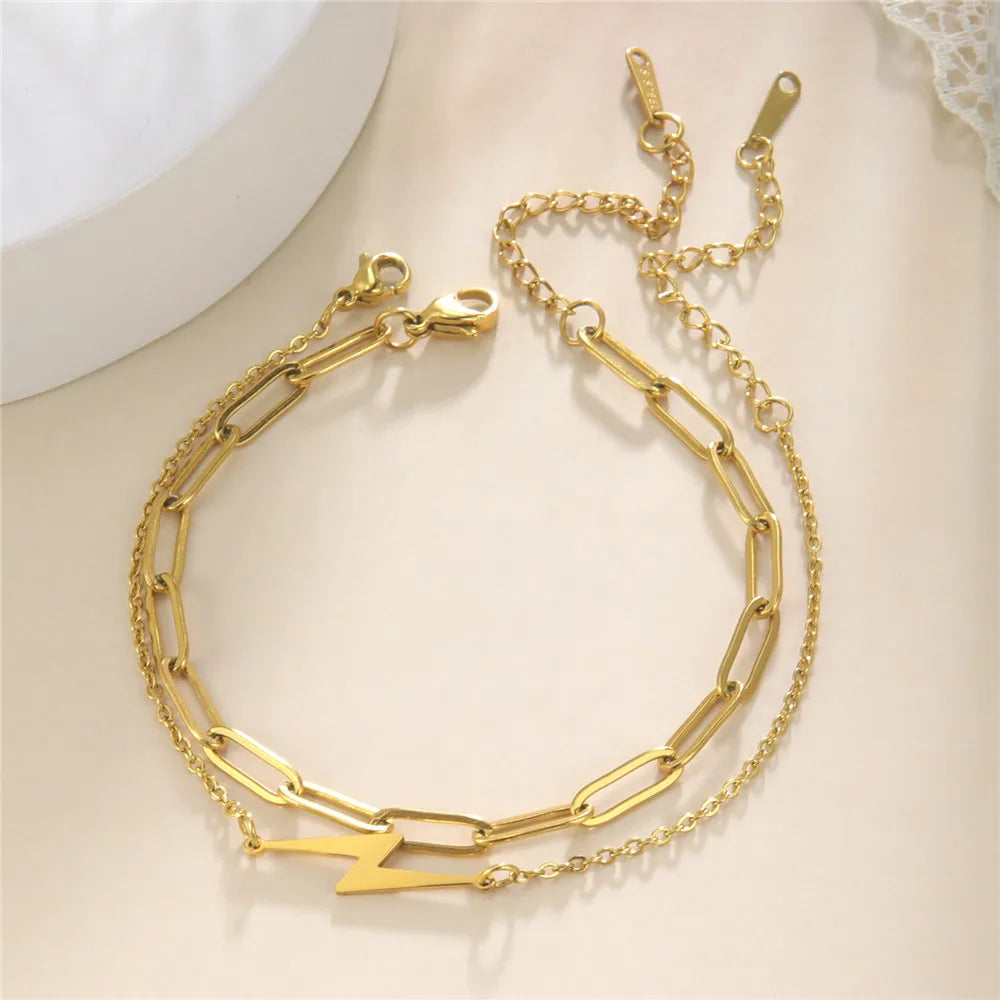 Gold chain charm bracelet with double rows and lightning bolt centerpiece