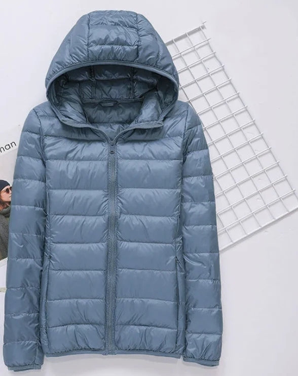 Light blue hooded puffer jacket with full-zip front and quilted paneling