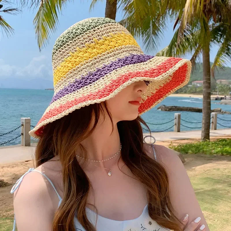 Rainbow striped crochet bucket hat worn by woman, side view with multi-color stripe bands