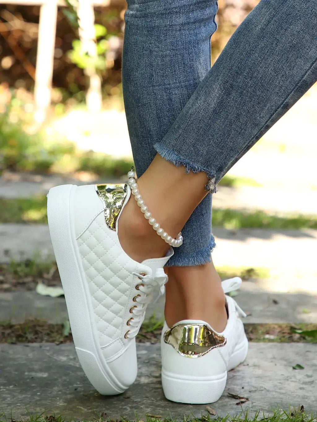 White quilted lace-up platform sneakers with gold eyelets, rear heel and sole.