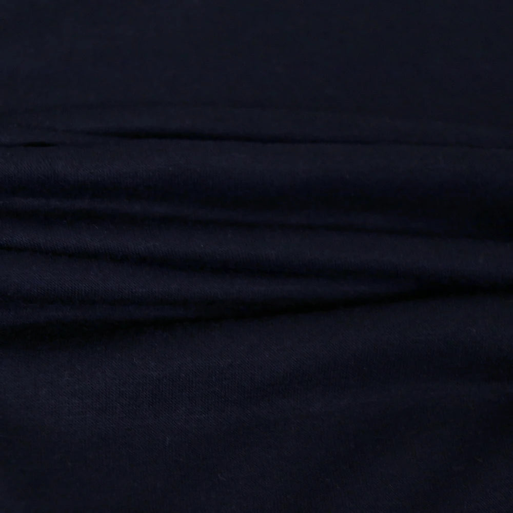 Black sleeveless top fabric close-up showing layered stitching detail