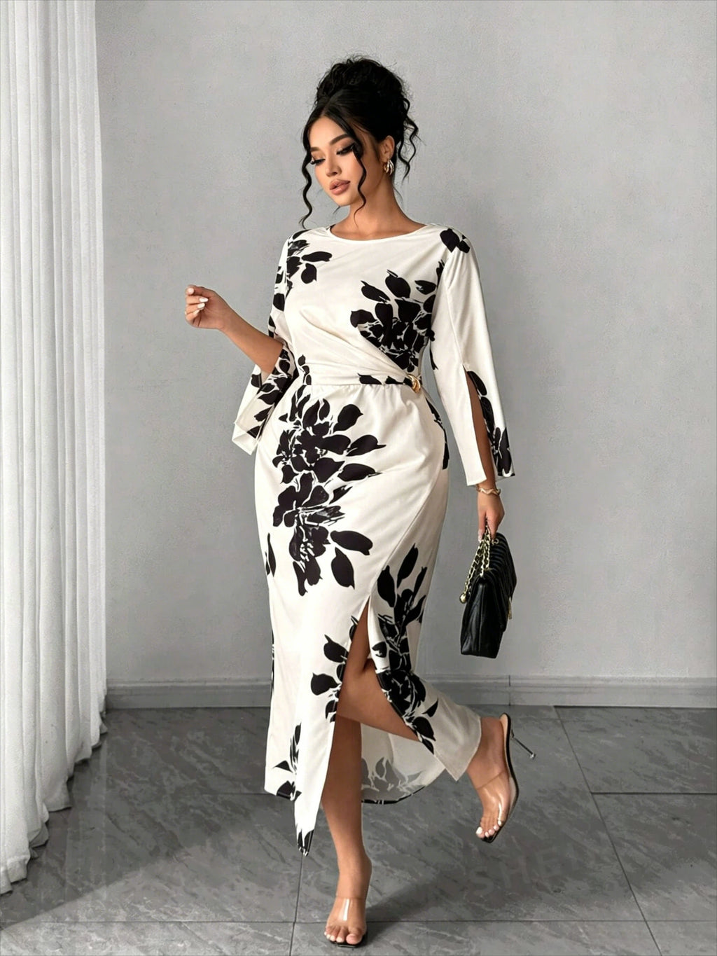 White midi dress with black floral print, long bell sleeves, side slit, belted waist