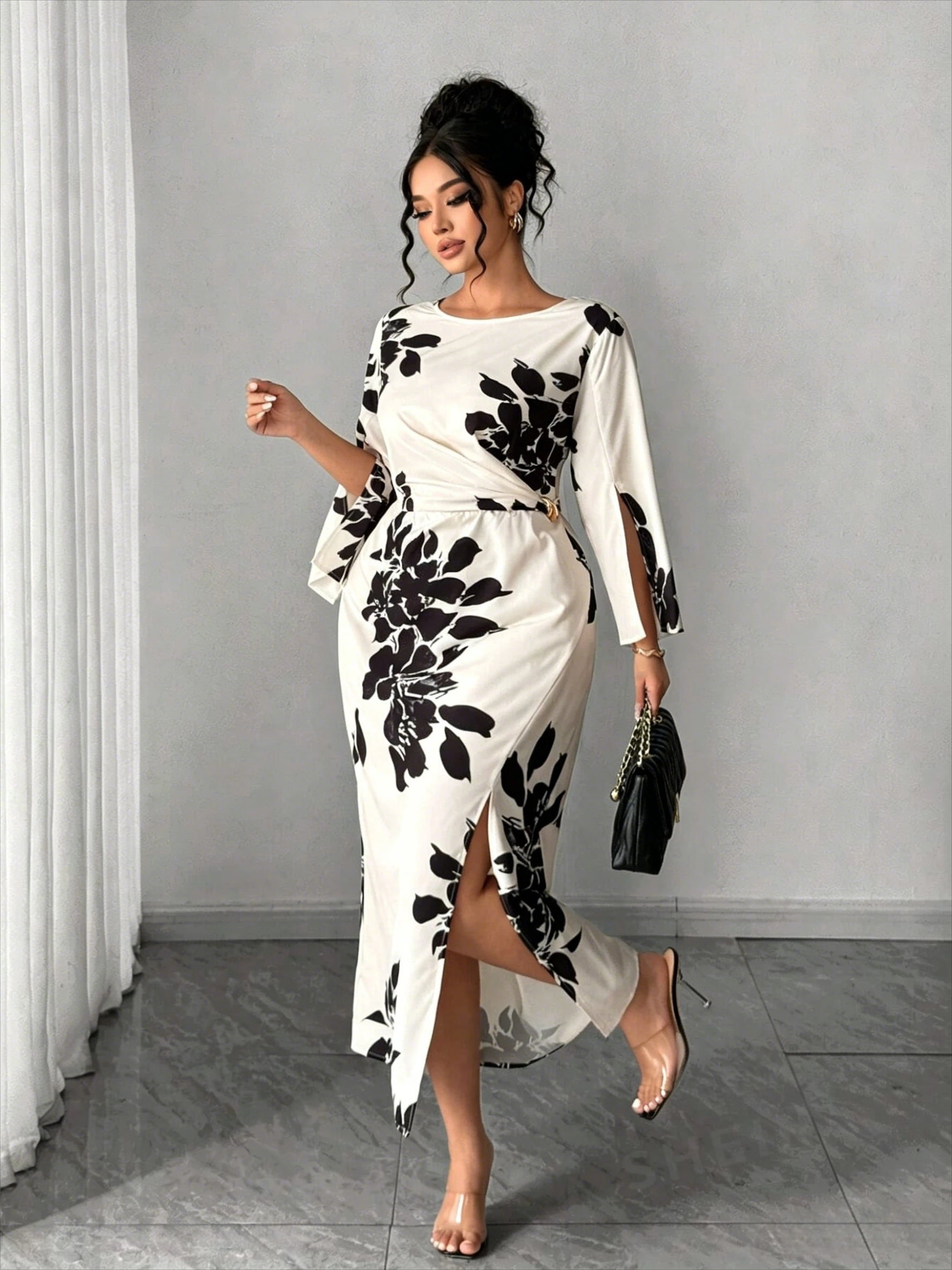White midi dress with black floral print, long bell sleeves, side slit, belted waist