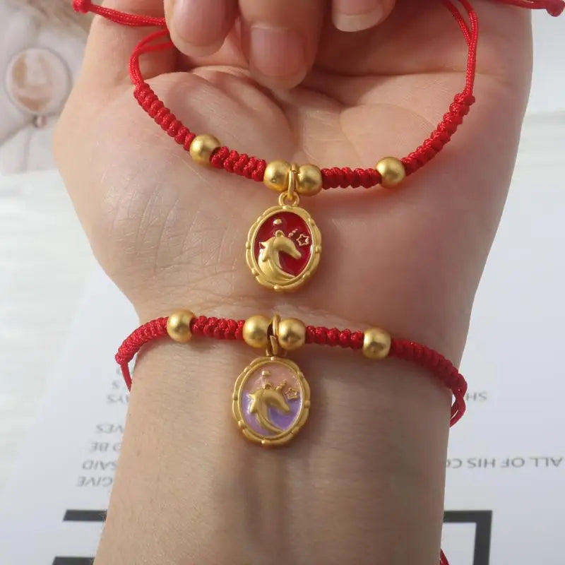 Red rope bracelet with gold round horse pendant and small gold beads