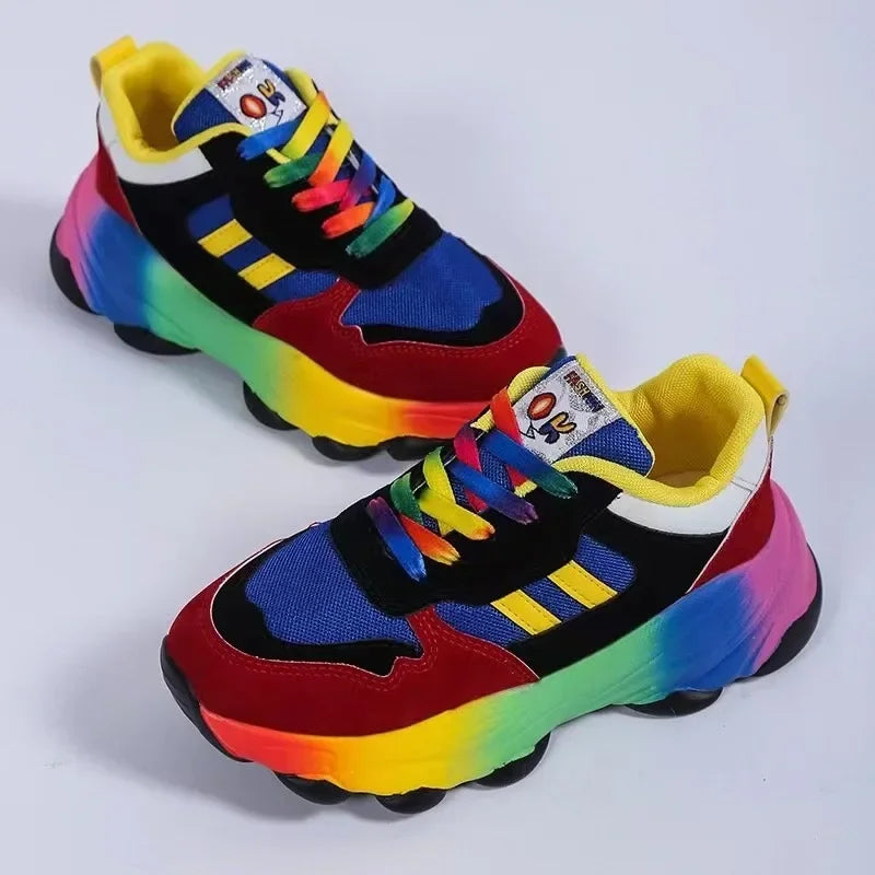 Color-block platform sneakers with black upper, red and blue accents, rainbow sole
