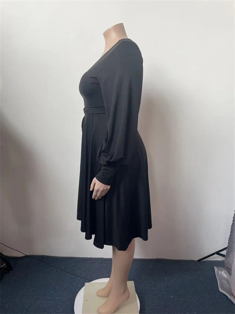 Black plus size V-neck dress with draped skirt and ruched waist