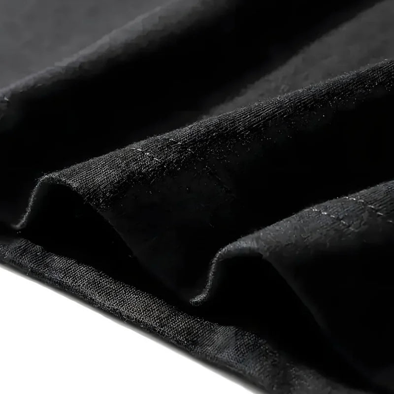 Women's black cotton T-shirt fabric texture and stitched hem close-up