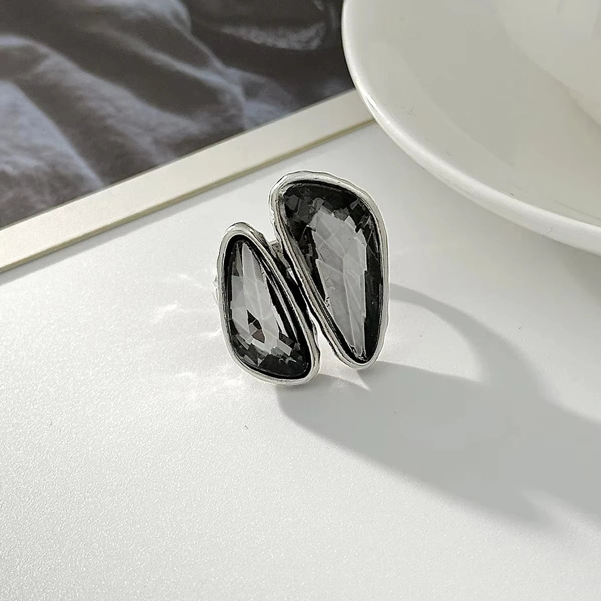 Silver open geometric ring with two black faceted oval rhinestones