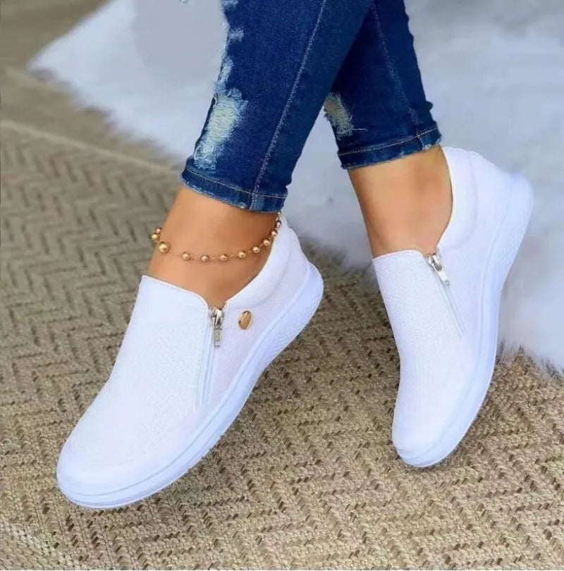 Women’s white side-zip slip-on sneakers with textured upper and white sole