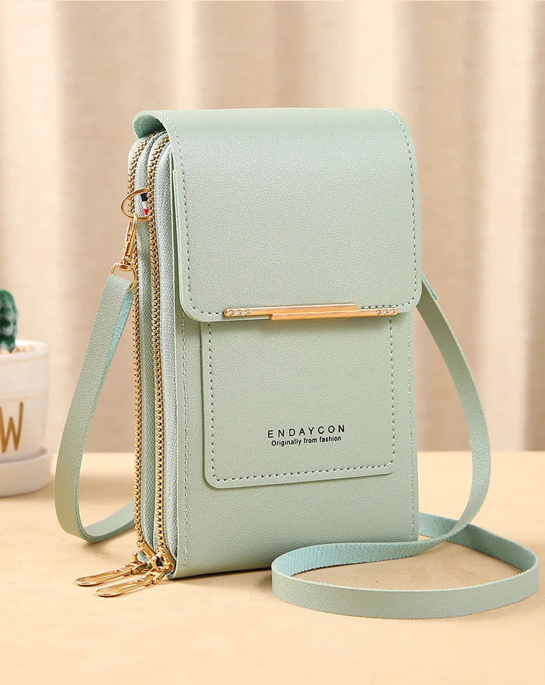 Light mint green PU phone crossbody wallet with top flap, gold zipper, and crossbody strap.