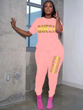 Light pink plus-size T-shirt and jogger set with yellow QUEEN print on chest and leg.
