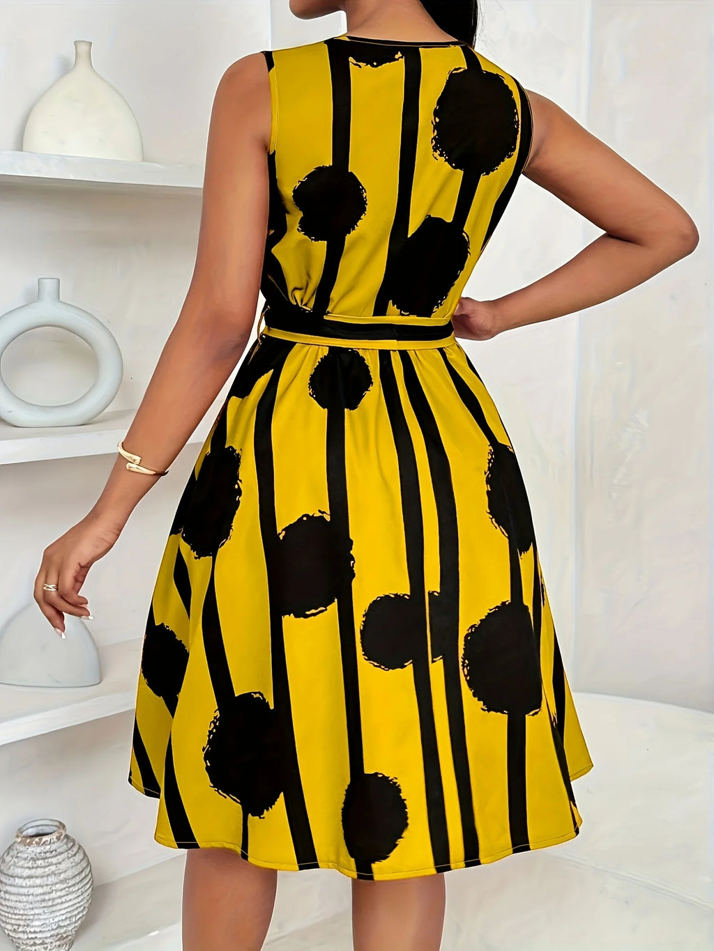 Plus-size sleeveless V-neck printed dress with tie waist, yellow with black dot-and-stripe