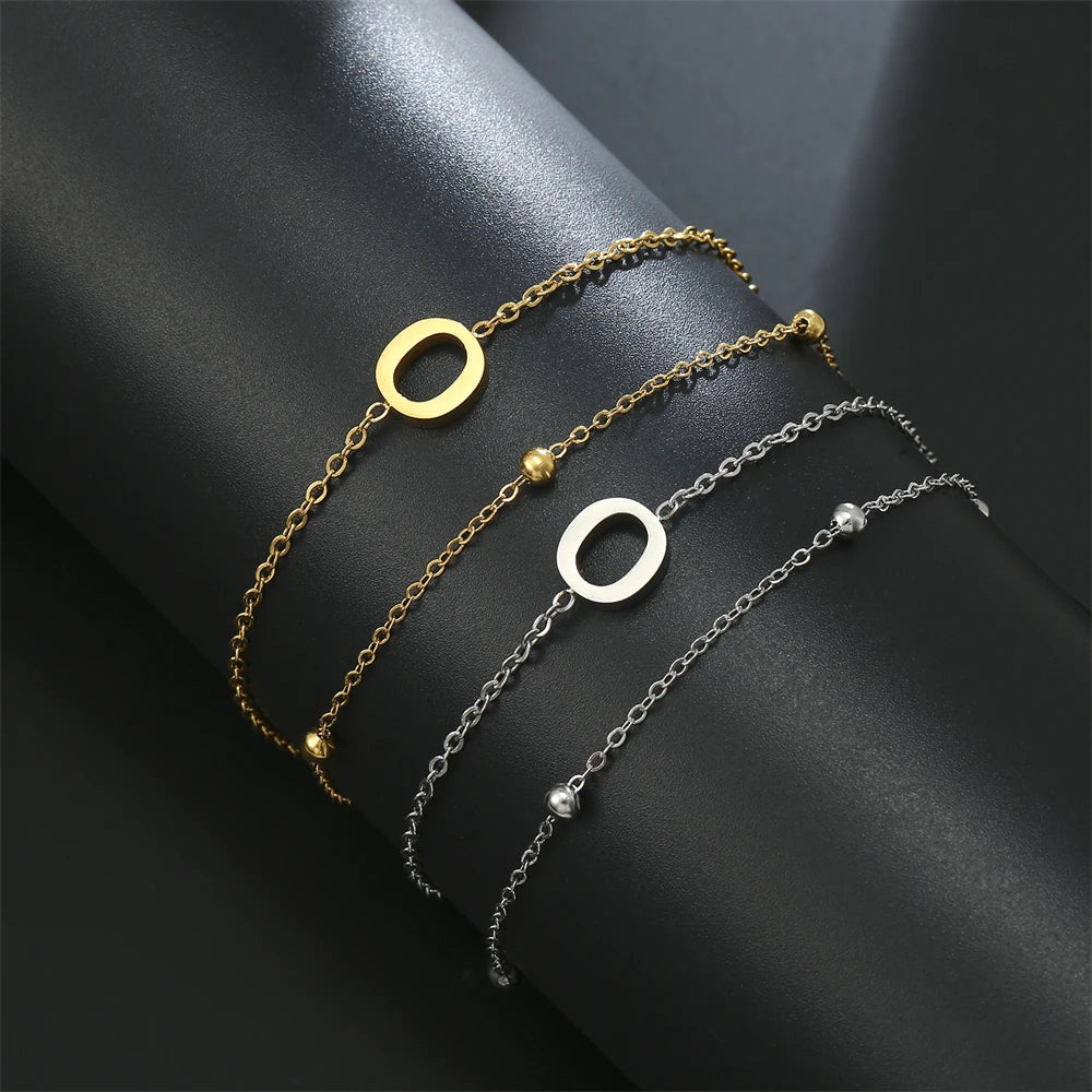 Initial letter bracelet set with O and O charms; gold and silver-tone chains