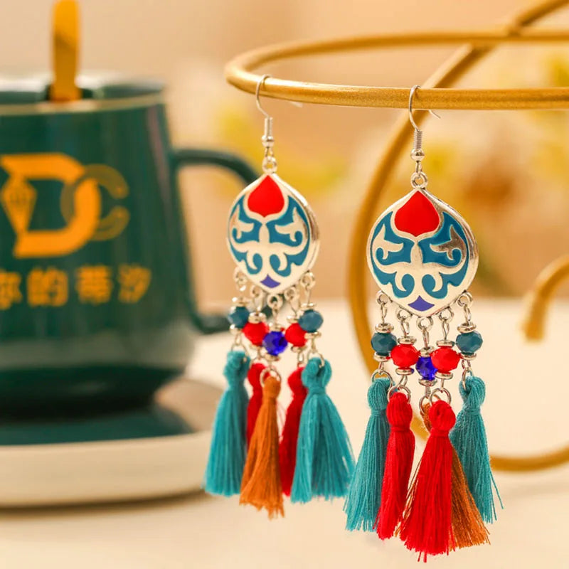 Boho tassel drop earrings with blue teardrop motif, red and turquoise tassels