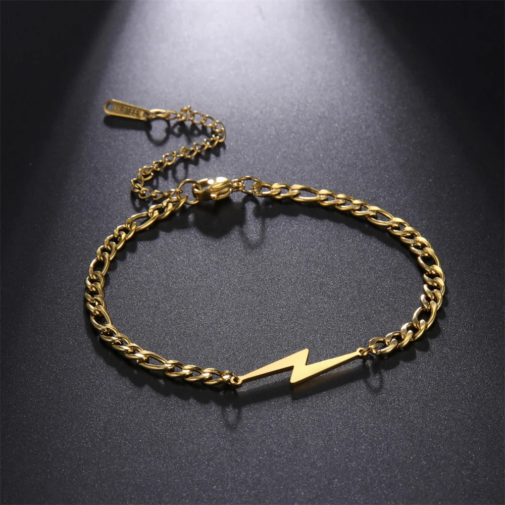 Gold tone lightning charm bracelet with chunky chain and white bolt centerpiece.