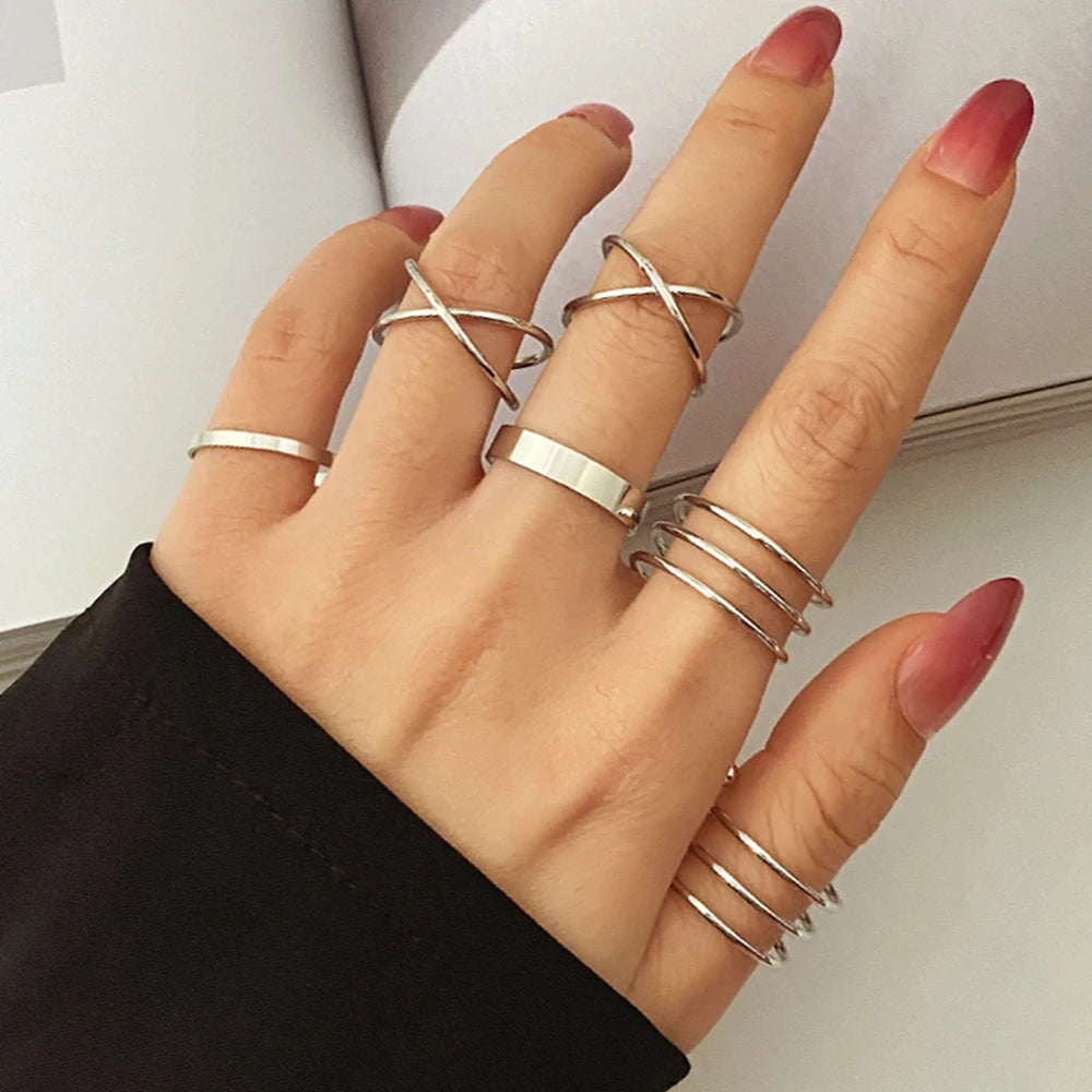 Silver knuckle ring set with linked bands and stacked finger rings