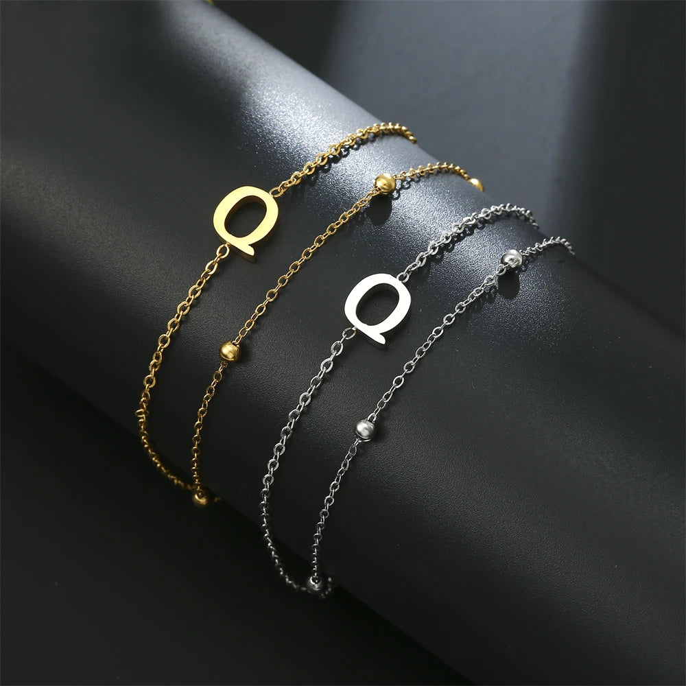 Initial letter bracelet set with Q and Q charms; gold and silver-tone chains