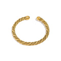 Gold-tone woven open bangle bracelet with twisted braid texture and flat clasp ends