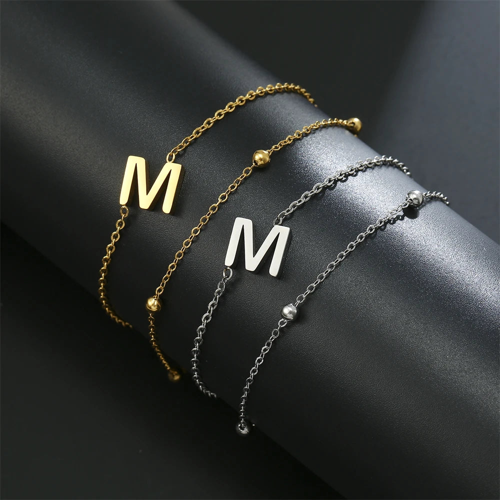 Initial letter bracelet set with M and M charms; gold and silver-tone chains