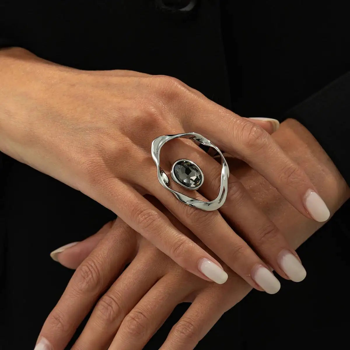 Silver open ring with oval dark faceted rhinestone centerpiece