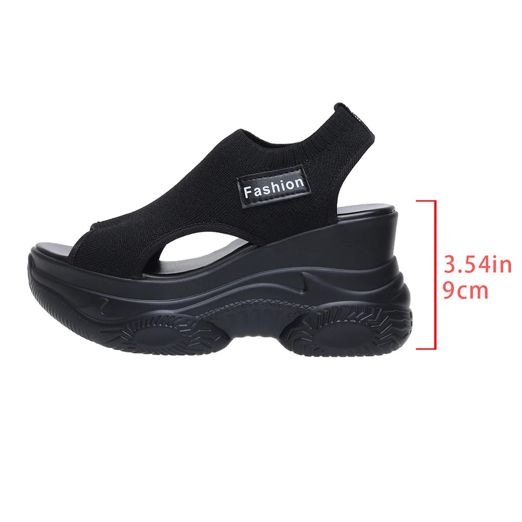 Black peep-toe platform wedge sandals with stretchy knit upper and textured sole