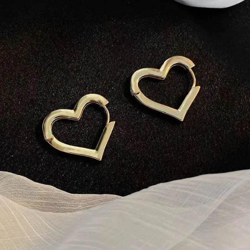Gold heart hoop earrings with hollow center, drop style