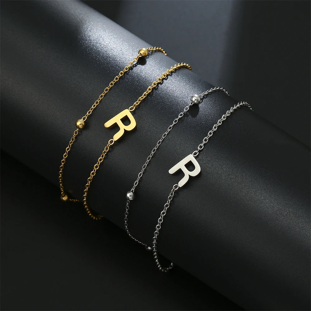 Initial letter bracelet set with R and R charms; gold and silver-tone chains